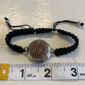 Adjustable braided black cord bracelet with one interchangeable snaps.NWOT